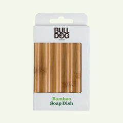 A box labeled Bamboo Soap Dish displays the soap dish through a clear window. This grooming accessory helps extend your soap’s life, with the product name printed in green on the lower part of the white packaging.
