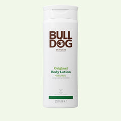 A white bottle of Bulldog Skincare’s Original Body Lotion, 250ml, with brown and green labeling, stands on a light background. Formulated with natural ingredients like Aloe Vera, it provides intense hydration for your skin.